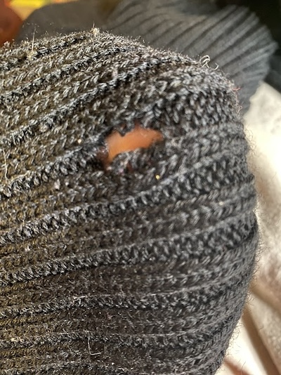 Photo of a sweater with a hole